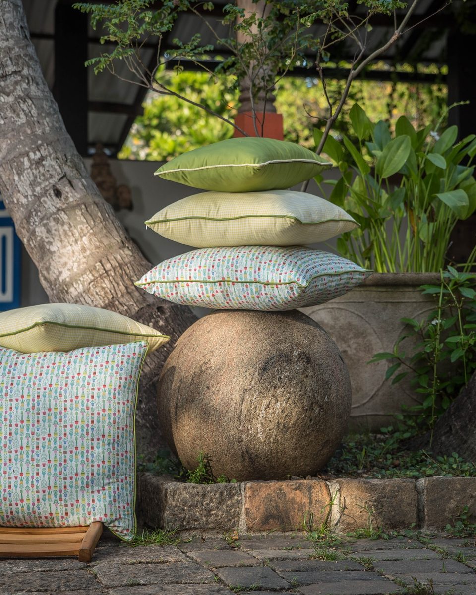 Cushions stacked and layered, solids against prints