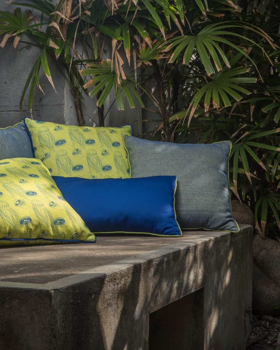Cushion set on a stone bench — chartreuse, blue and grey