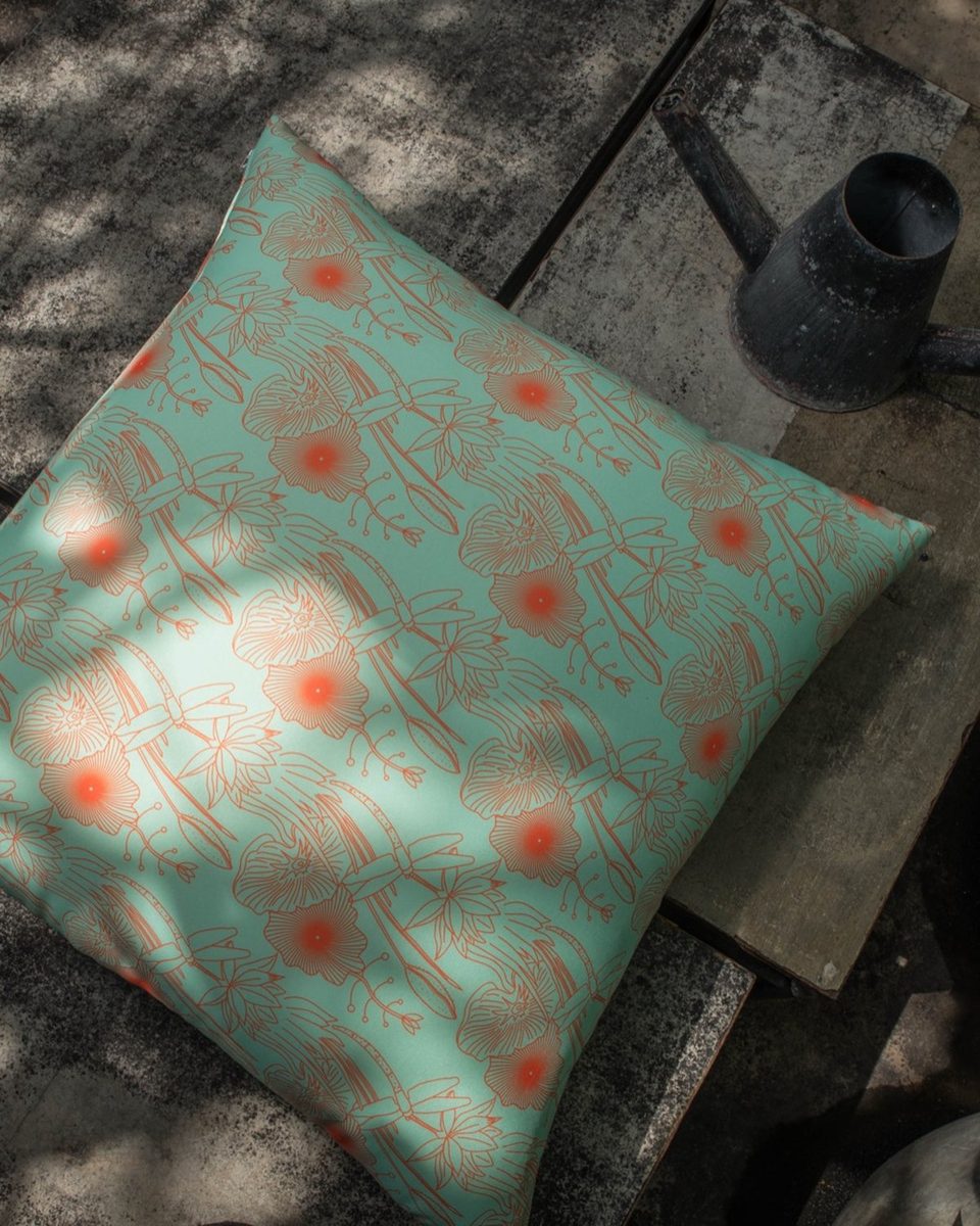 Dragonfly print cushion in teal and coral