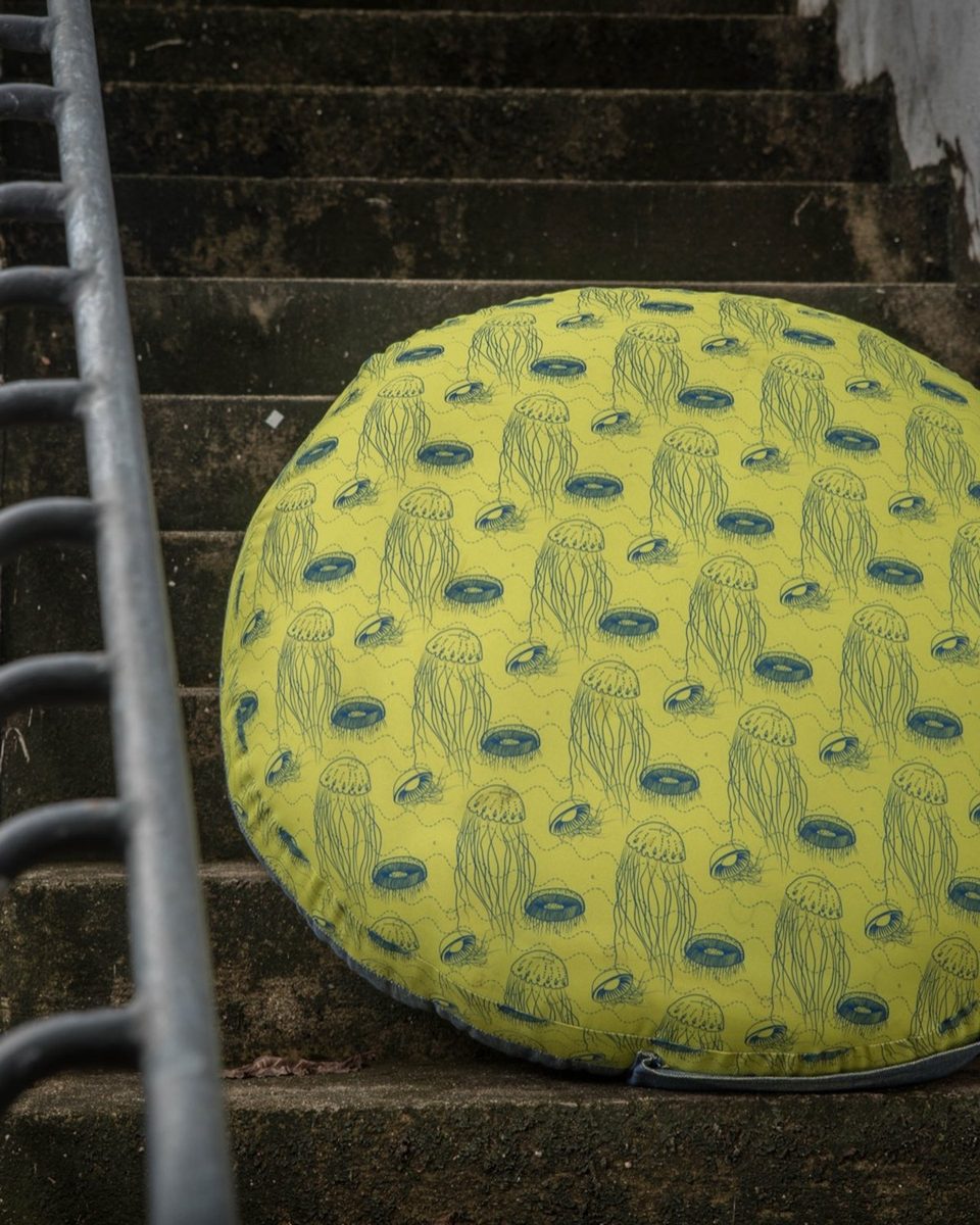 Jellyfish print round floor seater cushion on stone steps