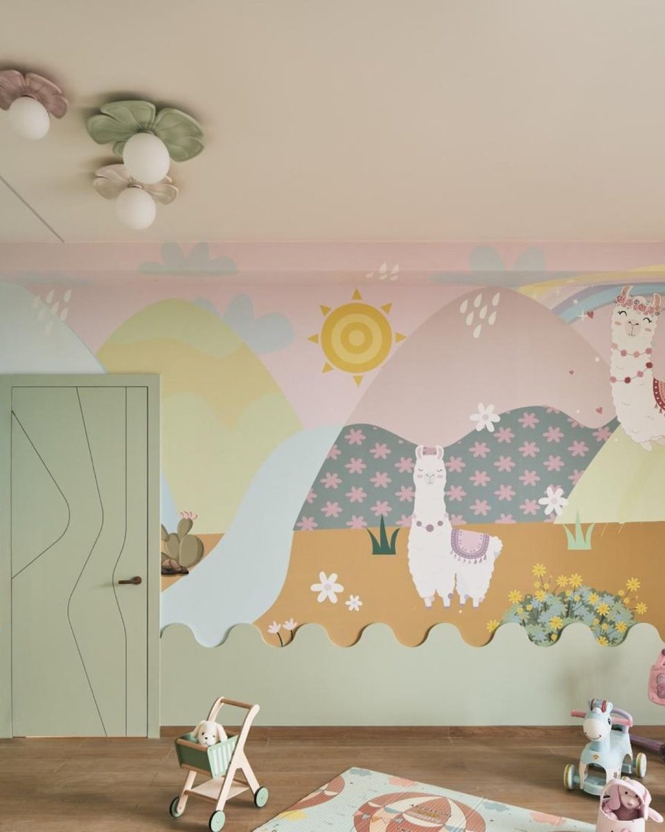 Full desert-scape nursery mural with wandering llamas, a rainbow and scalloped cactus border