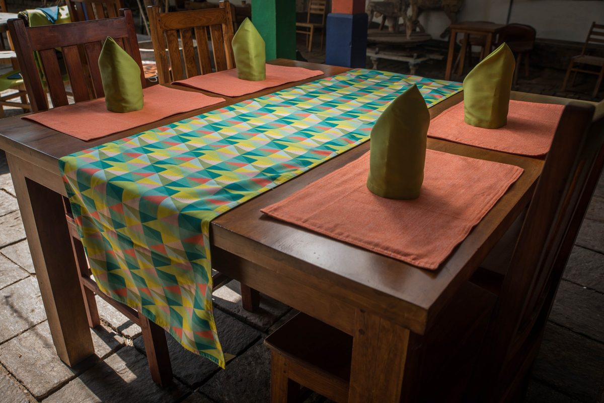 Geometric table runner with terracotta placemats and green napkins