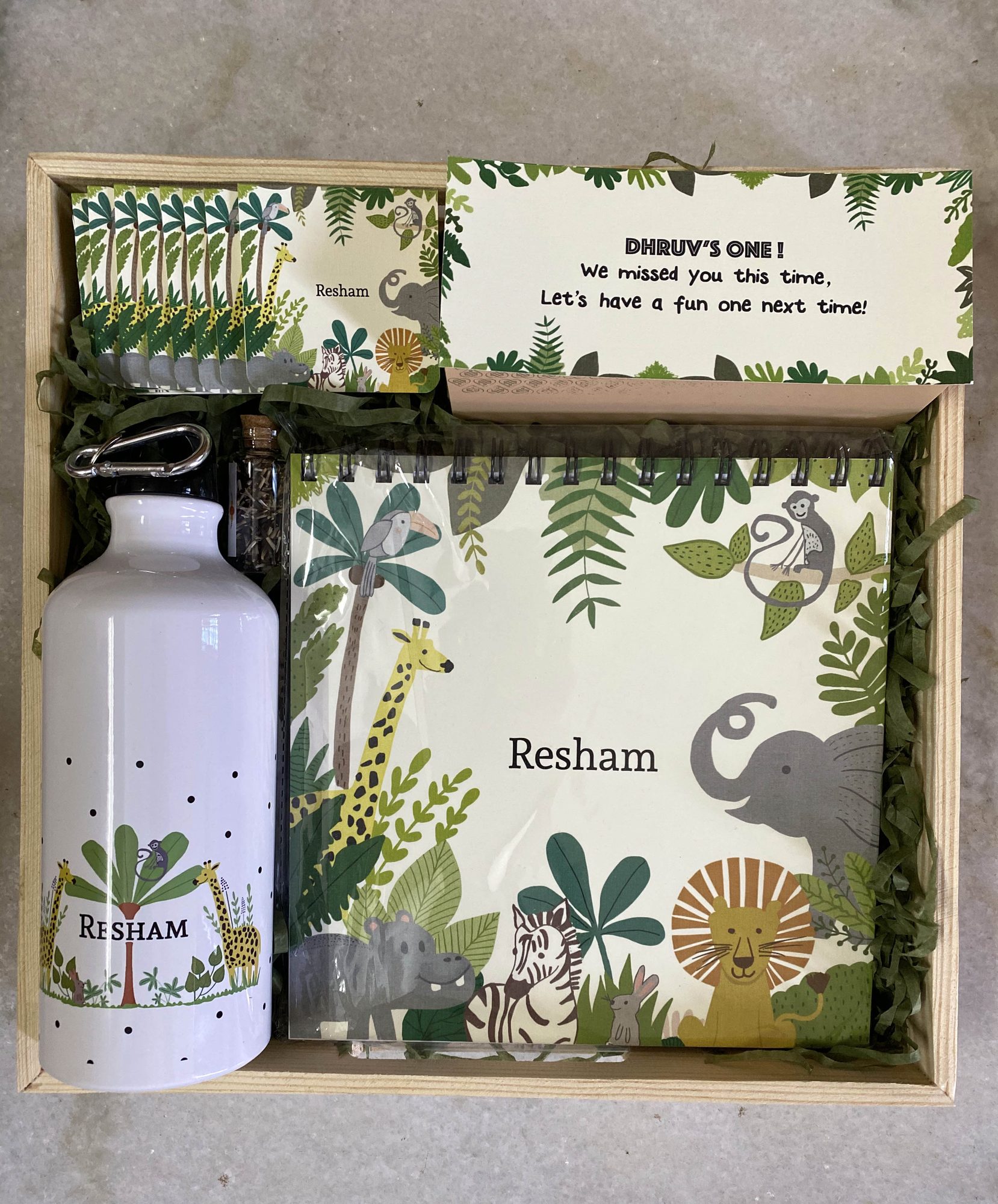 A personalised gift crate — illustrated bottle, notebook and card