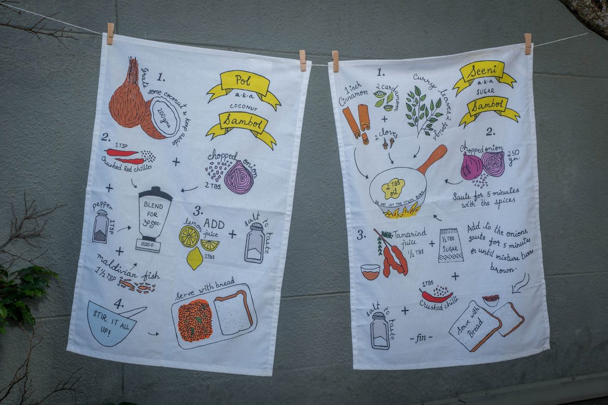 Pol and Seeni Sambol tea towels hung on a line
