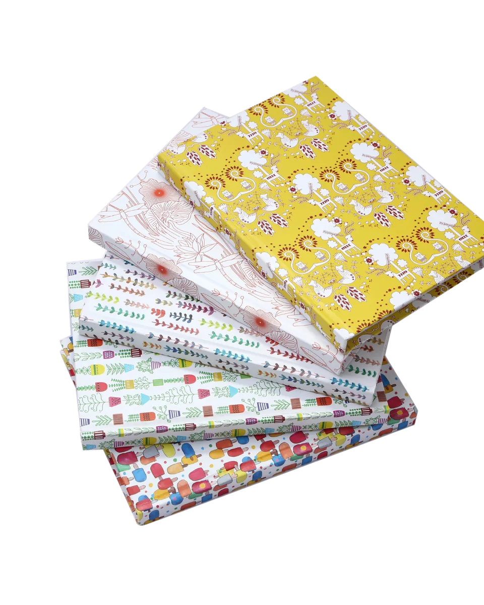 Hardbound notebooks in a stack, printed covers